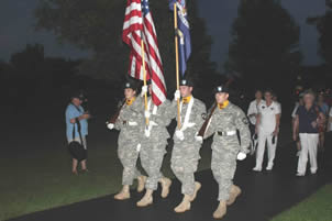 grave stones with flags and carnations