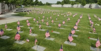 grave stones with flags and carnations