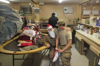 soldier sitting on santa soldier's lap